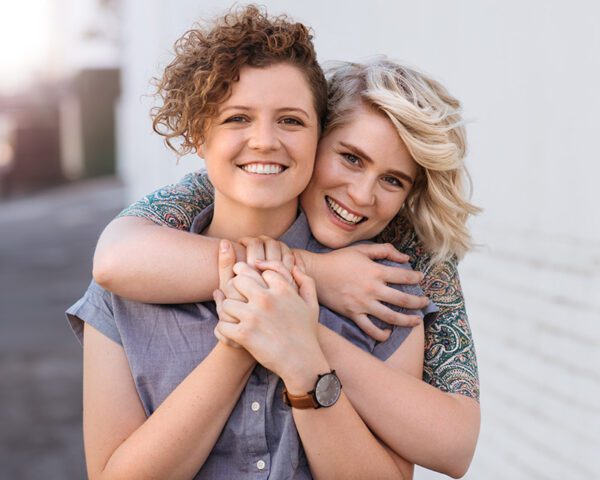 Lesbian couple hugging after couples therapy online - Connecticut couples therapist