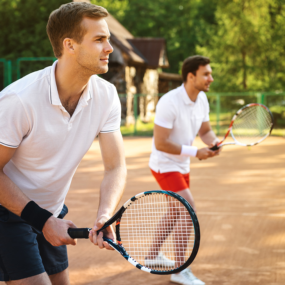 Men playing tennis outside considering therapy for men's issues in Connecticut - Fairfield, Norwalk, Darien, Westport, Bridgeport, Southport, Stamford