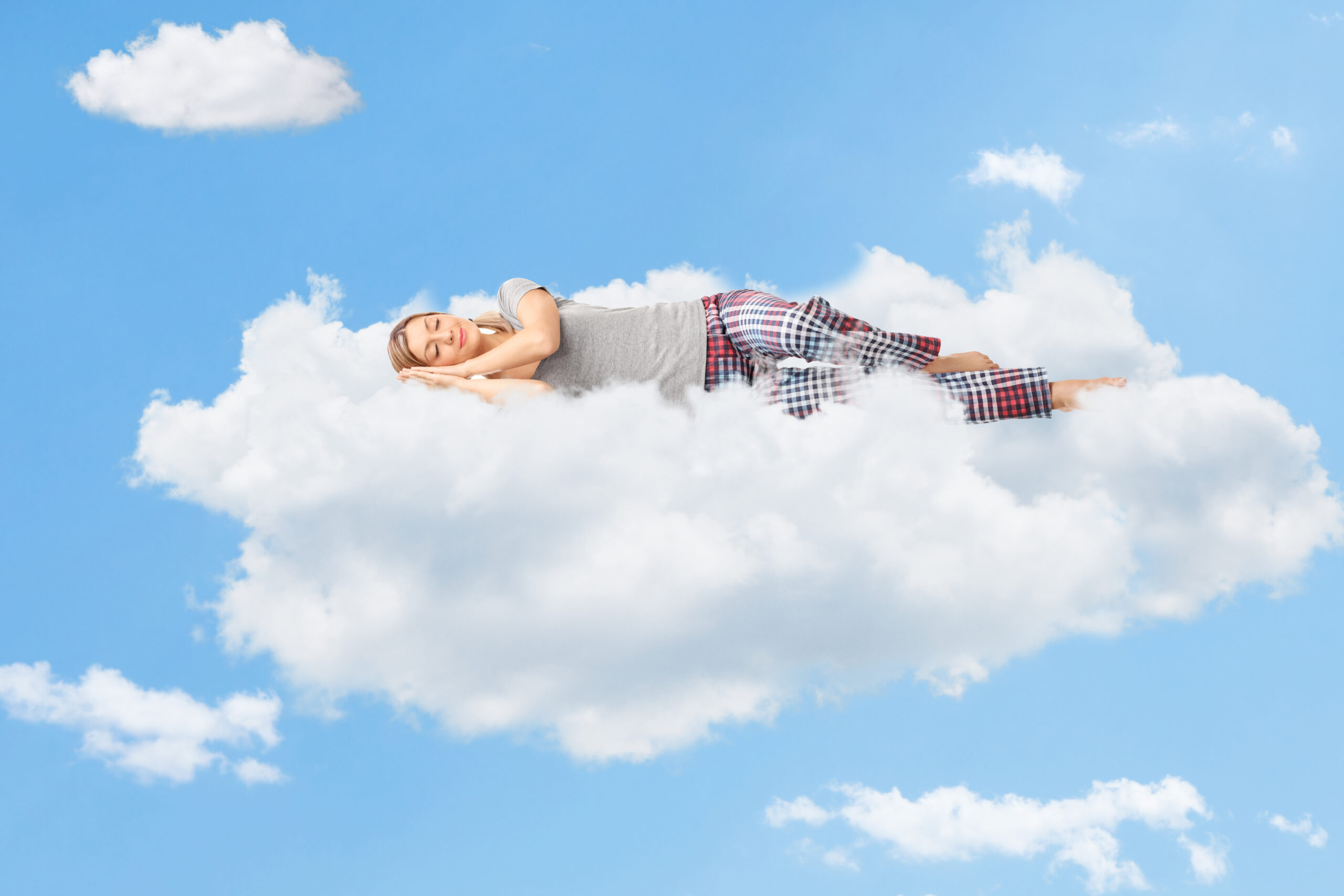 Woman sleeping peacefully on a cloud