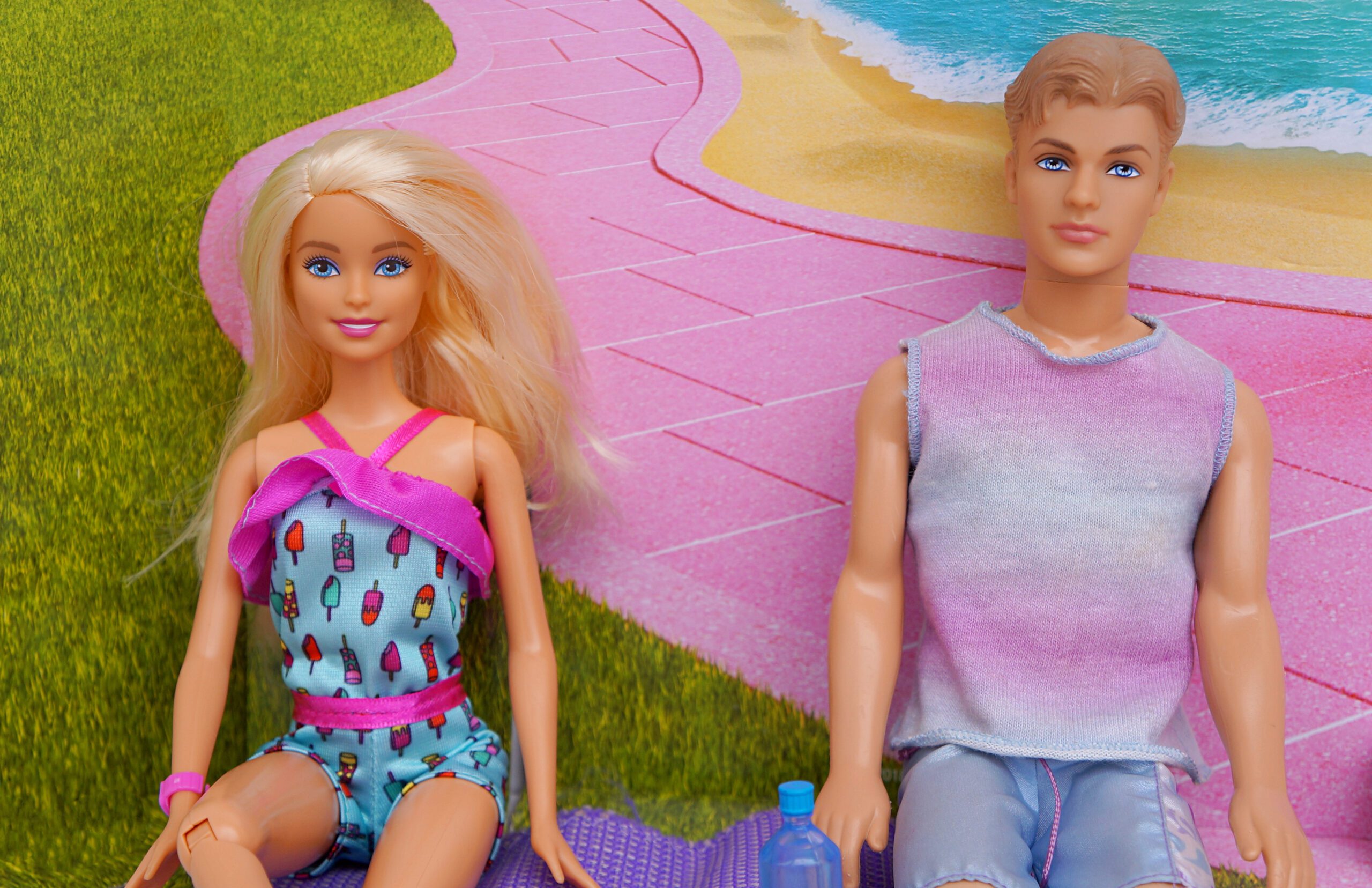 Barbie and Ken sitting next to each other