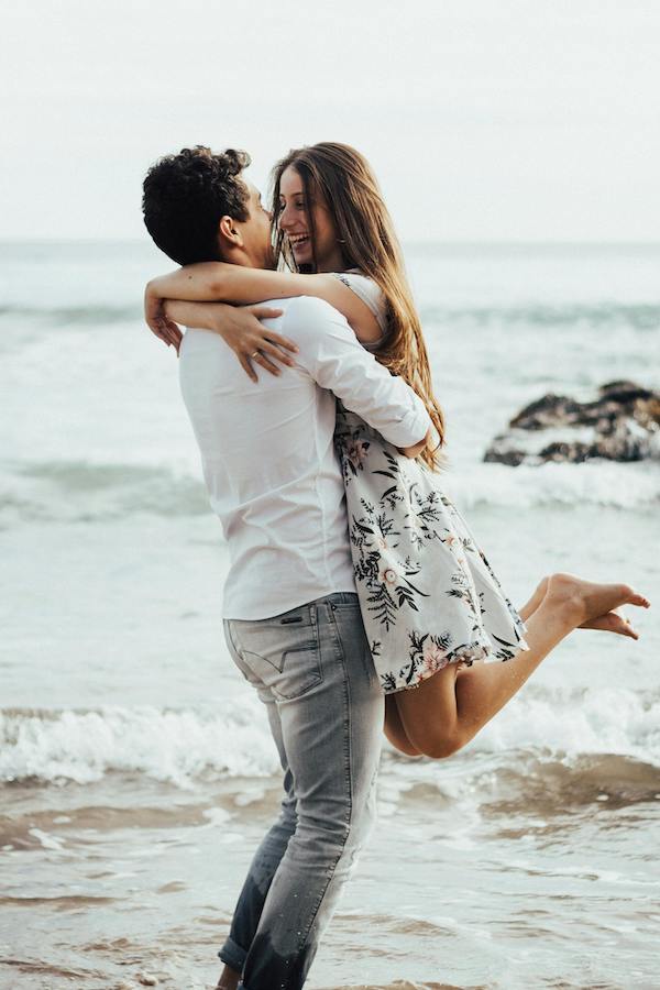 Happy Couple hugging on beach