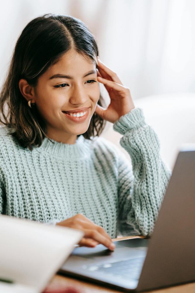 Young woman smiling on laptop