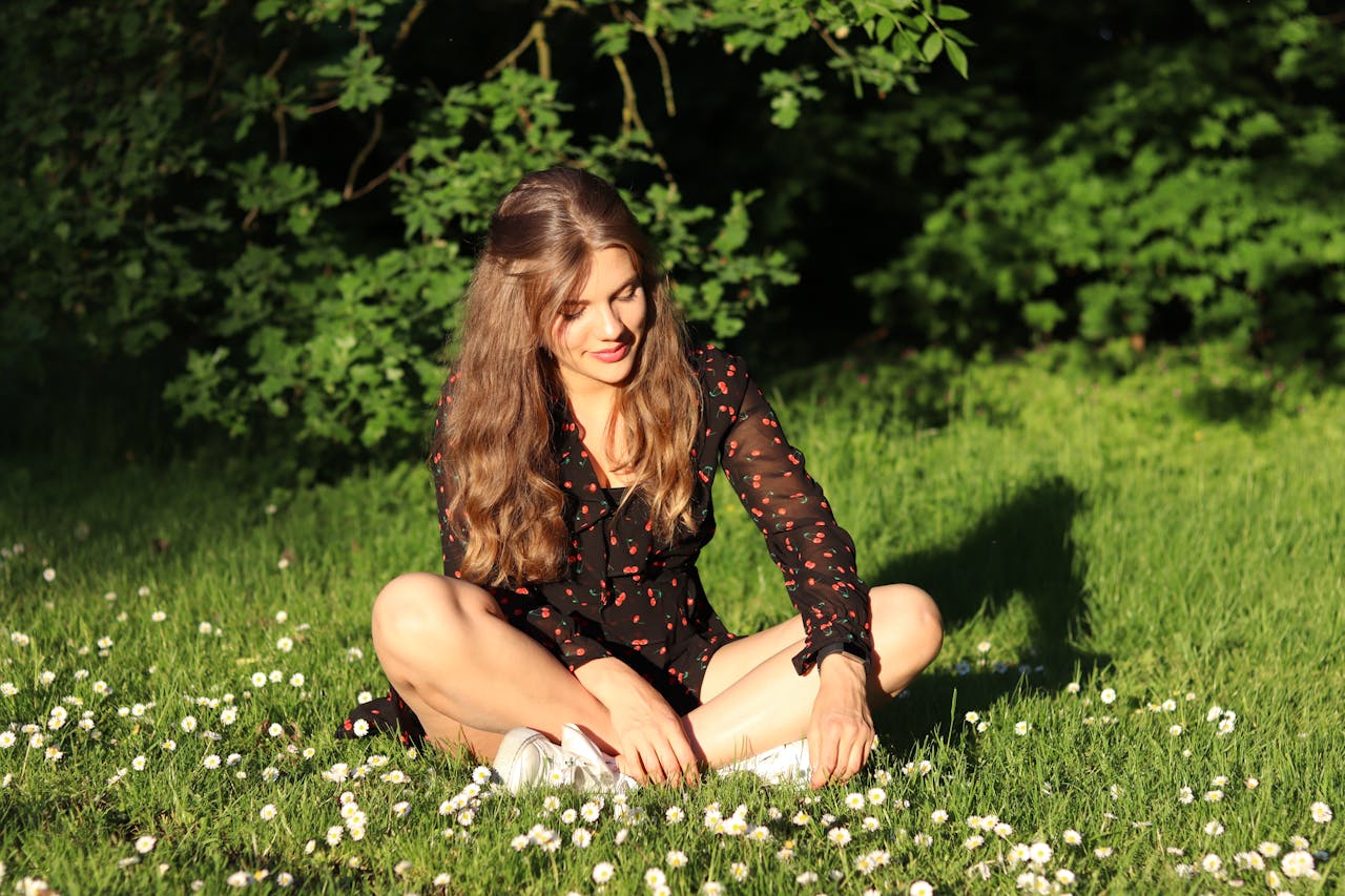 oman Wearing Red and Brown Mesh Dress Shirt Sits on White Flower Field