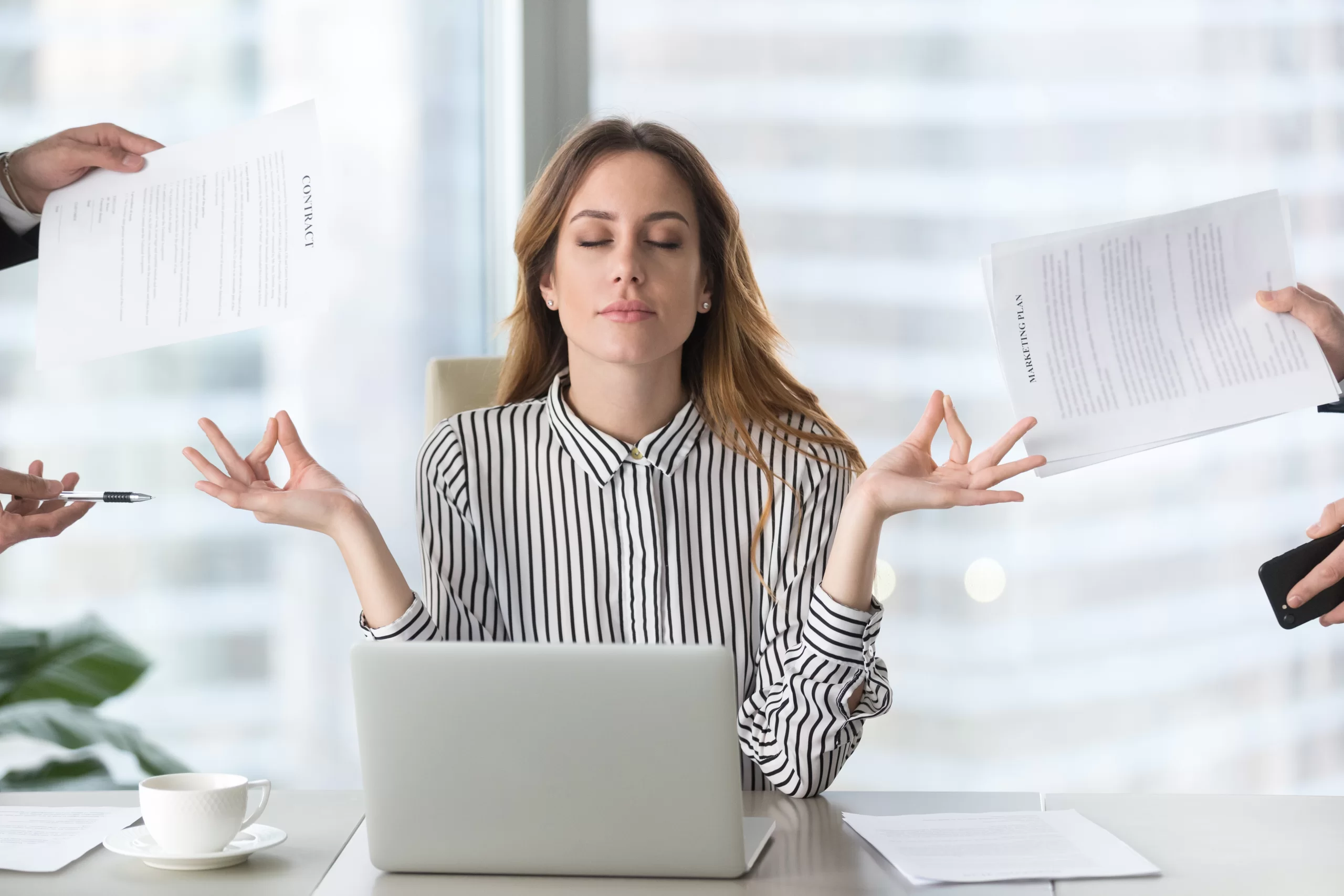 Calm female executive meditating taking break avoiding stressful job Calm female executive meditating taking break at work to manage anxiety