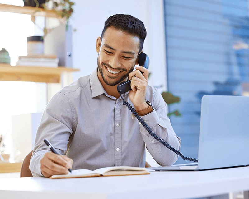 therapy_professionals Man working at a desk feeling good about professional and personal life